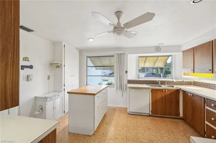 Kitchen with ceiling fan, dishwasher, and sink