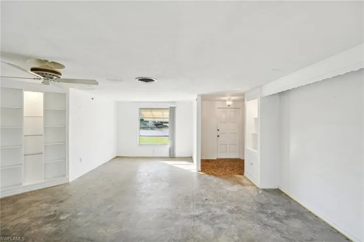 Unfurnished room with ceiling fan and concrete floors