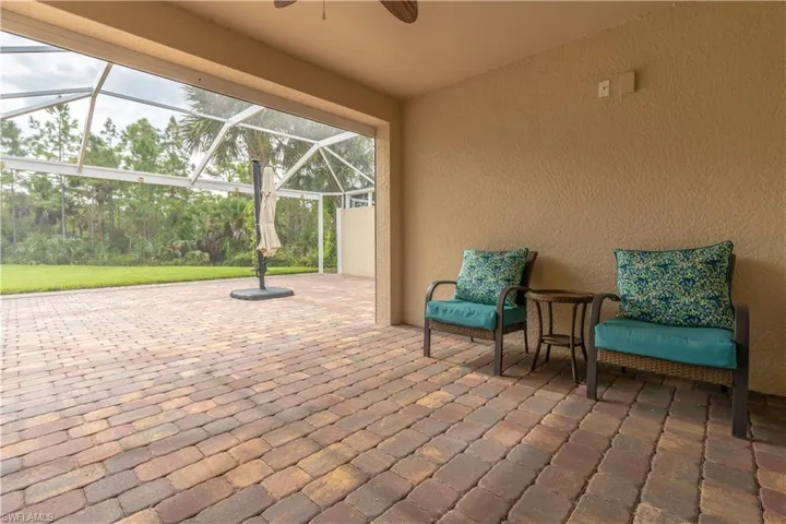 View of patio / terrace with ceiling fan and glass enclosure