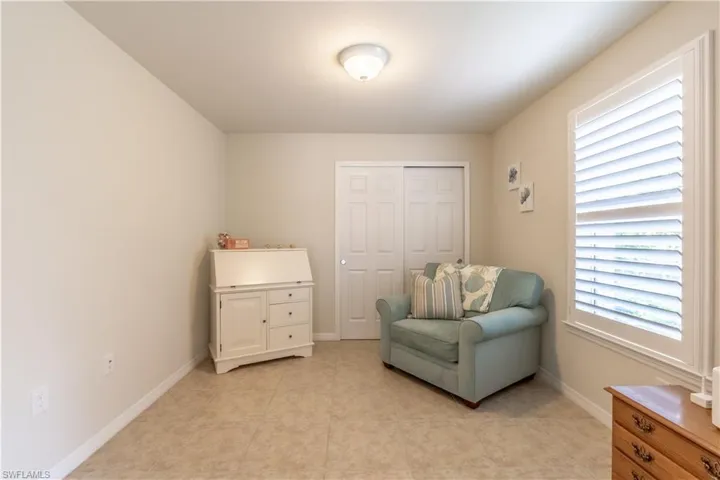 Sitting room with light tile patterned floors and plenty of natural light