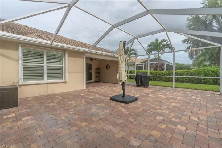 View of patio featuring grilling area, a lanai, and ceiling fan