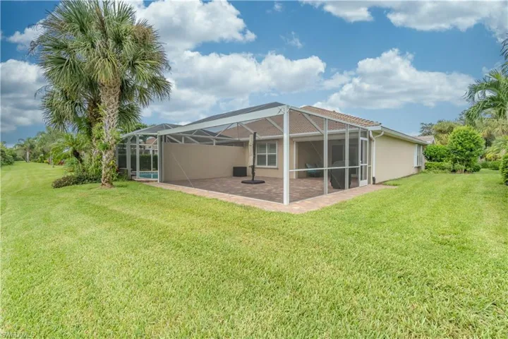 Back of house featuring a yard, a lanai, and a patio area