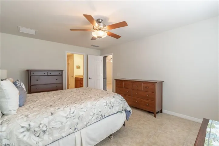 Bedroom featuring connected bathroom and ceiling fan