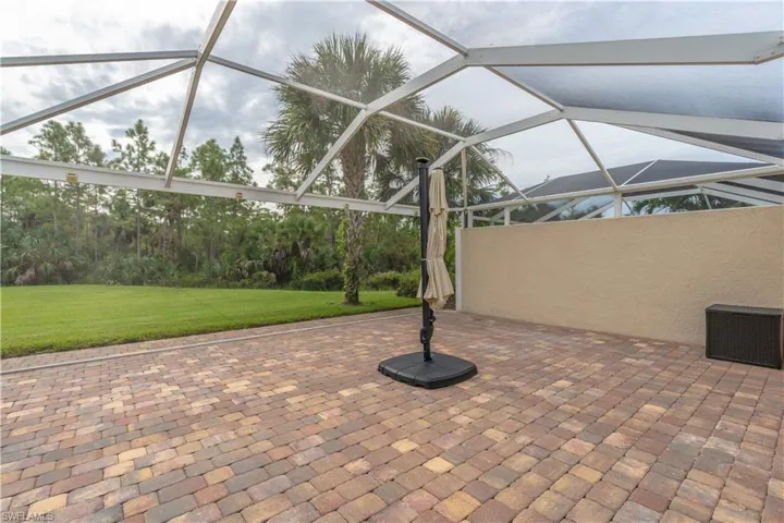 View of patio featuring a lanai