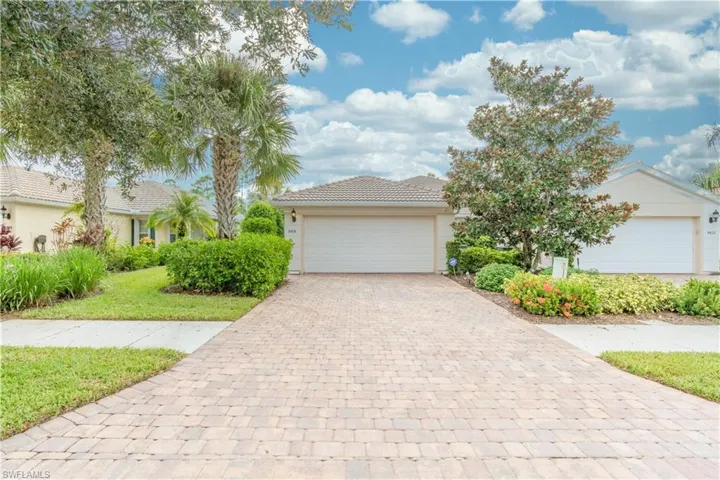View of front of home featuring a front lawn and a garage