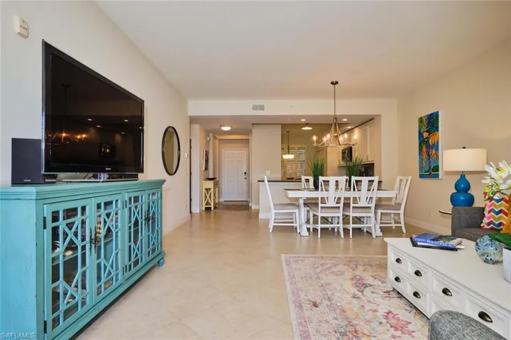 Living area featuring a chandelier and baseboards