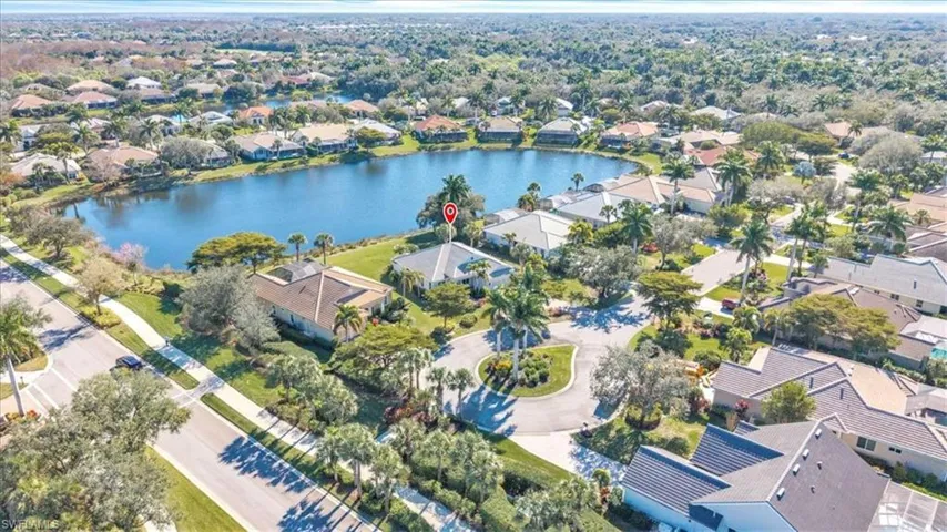 Aerial view of property's location featuring a large body of water and nearby suburban area