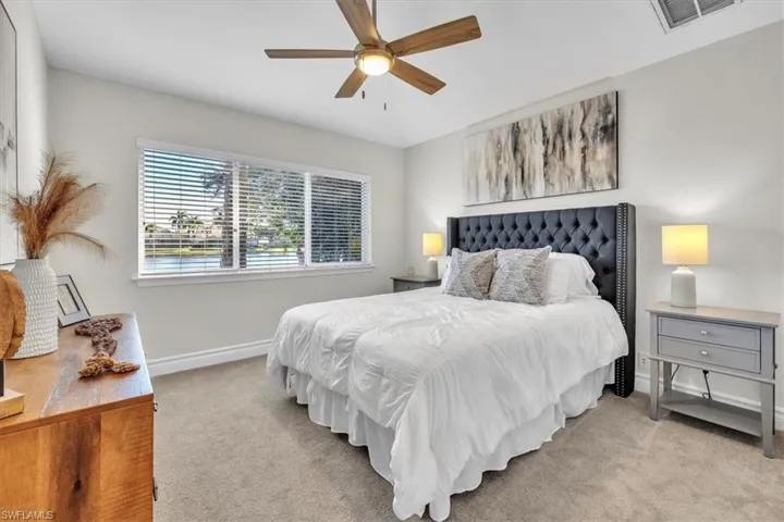 Carpeted bedroom with baseboards and ceiling fan