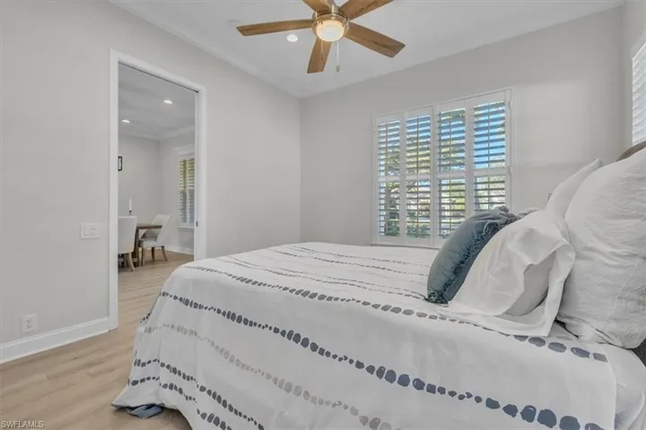 Bedroom with recessed lighting, light wood-type flooring, crown molding, and ceiling fan