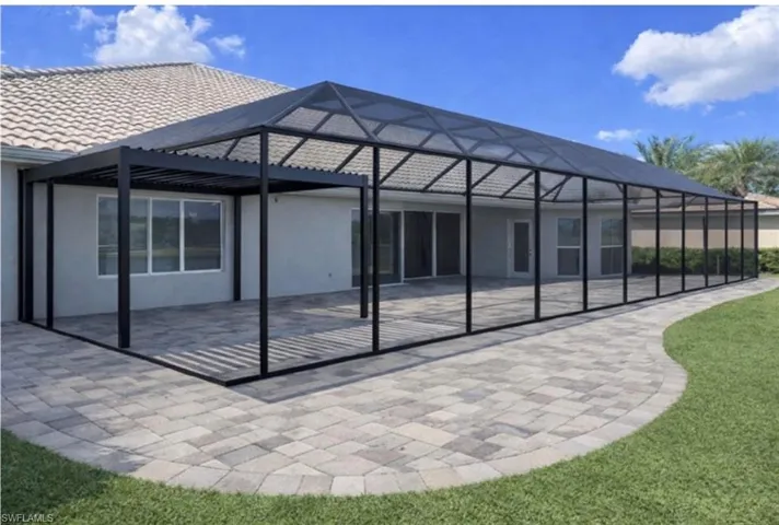 Moc of enclosure, a patio area, a lawn, and a sunroom