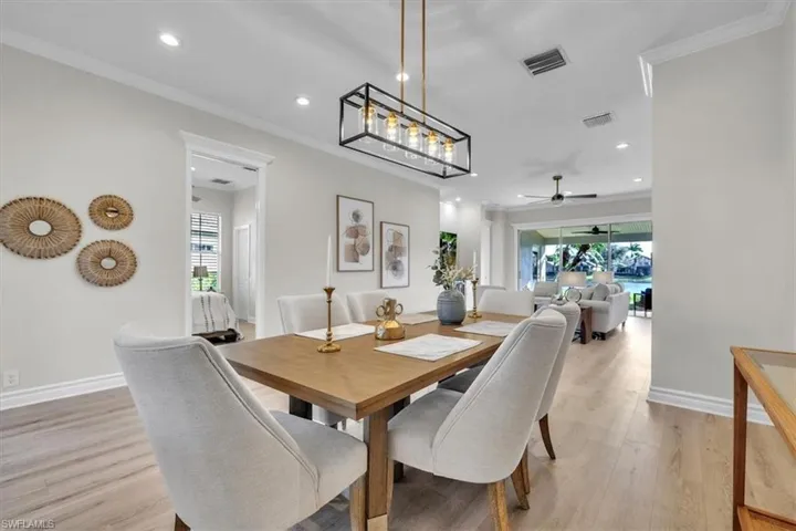 Dining space featuring crown molding, light wood-style floors, recessed lighting, and ceiling fan