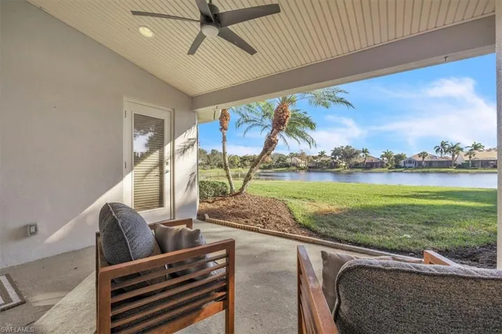 View of patio featuring ceiling fan, a residential view, and a water view