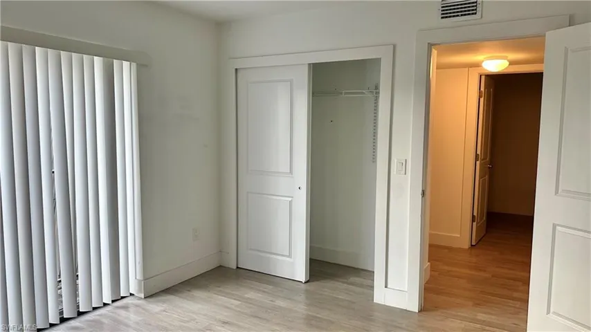 Unfurnished bedroom with light wood-style flooring and a closet