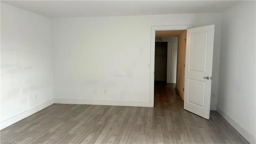 Spare room featuring wood finished floors
