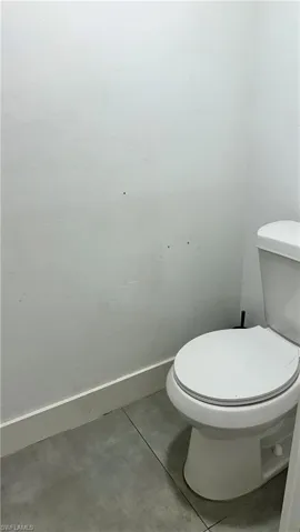 Bathroom with tile patterned floors and baseboards