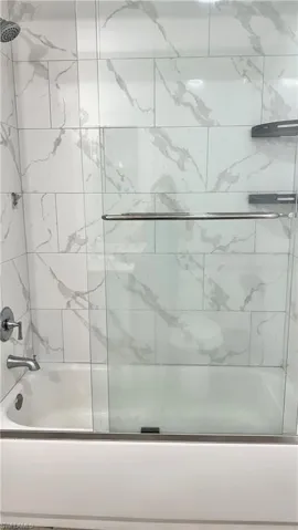 Bathroom featuring enclosed tub / shower combo