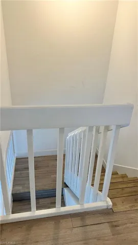 Stairs featuring wood finished floors