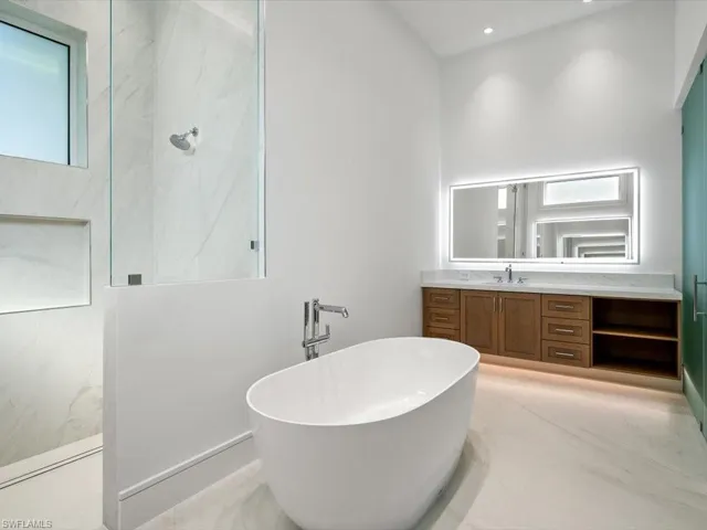 Master Bathroom featuring vanity and separate shower and tub