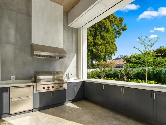Big outdoor kitchen with built-in cabinets for cooking or pool supplies