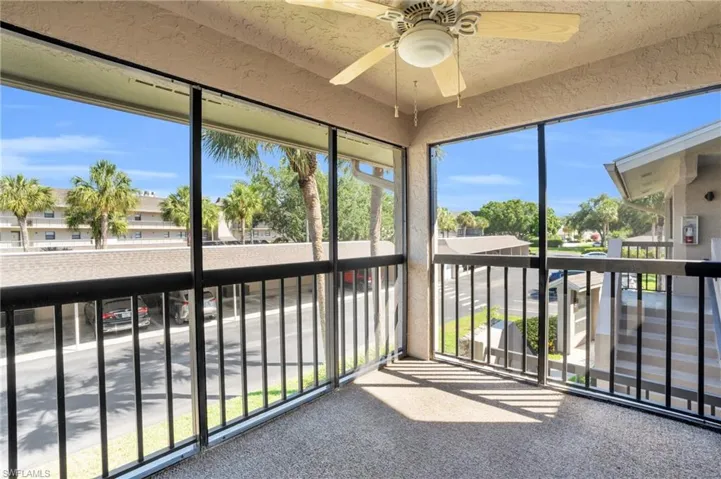 Unfurnished sunroom with ceiling fan