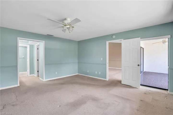 Unfurnished room featuring carpet and ceiling fan