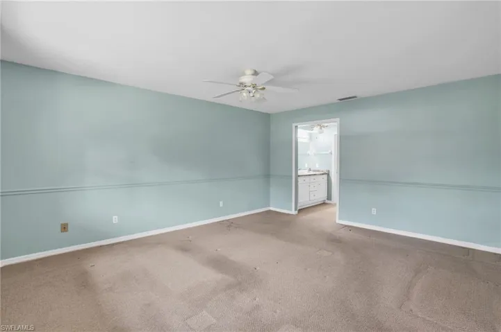 Carpeted spare room with ceiling fan