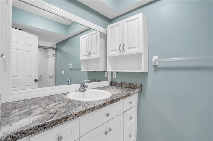 Bathroom with a tile shower and vanity