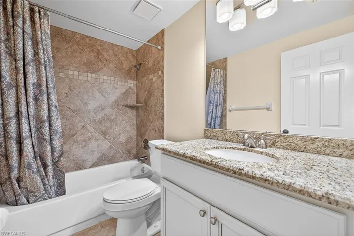 Full bathroom with shower / bath combo and vanity