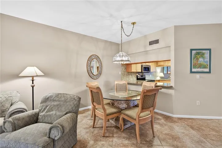 Dining area featuring baseboards and hanging lights