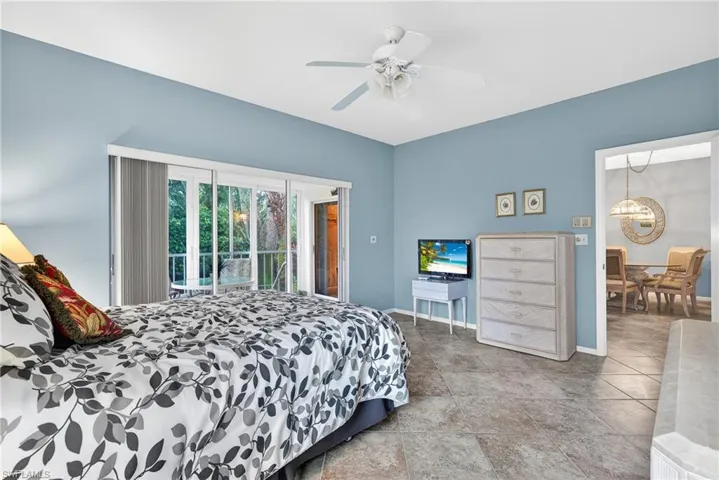 Bedroom with access to exterior, ceiling fan, and suspended lighting