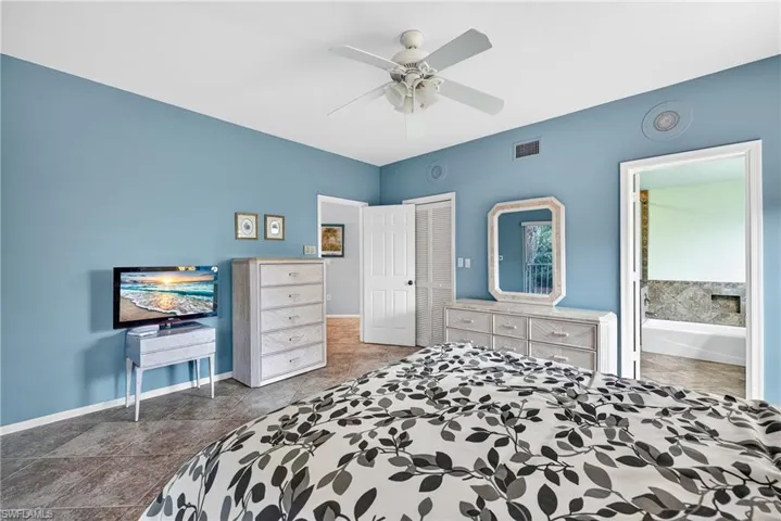Bedroom with a ceiling fan and a closet