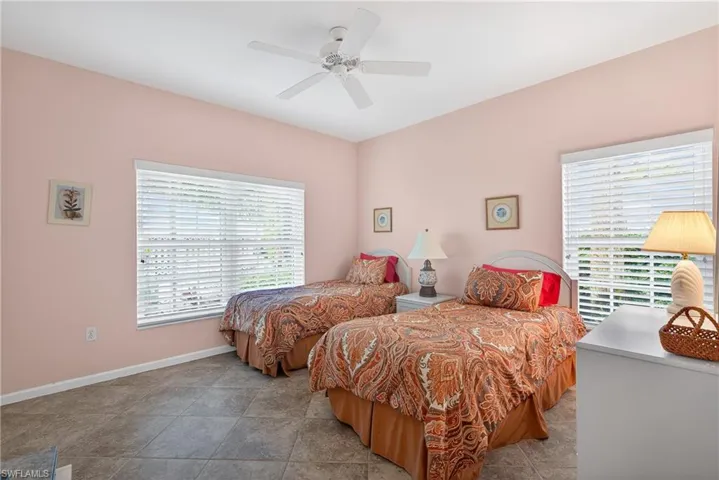 Bedroom featuring ceiling fan and baseboards