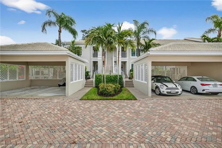 View of front of home with stucco siding and a tile roof