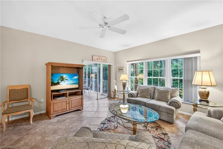 Living area featuring ceiling fan and baseboards