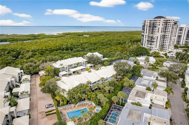 Drone / aerial view of a large body of water and a heavily wooded area