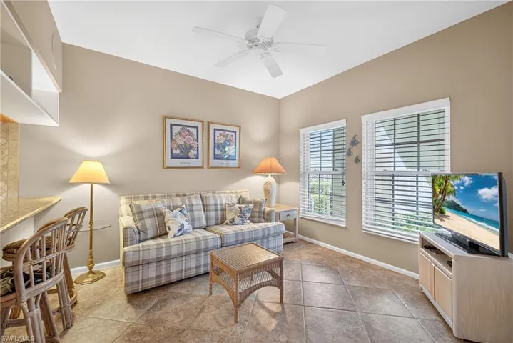 Living area featuring ceiling fan and baseboards