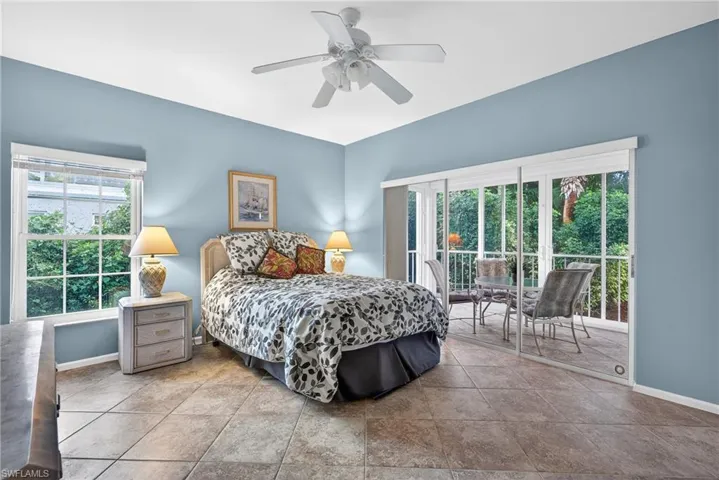 Bedroom with access to outside and ceiling fan