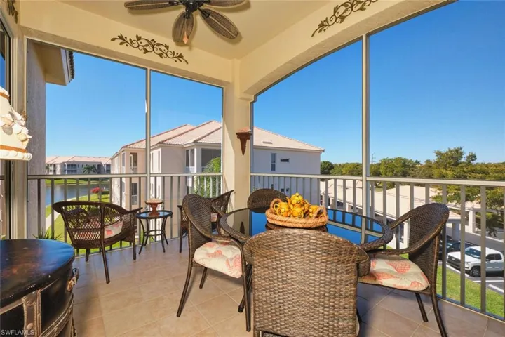 Sunroom / solarium featuring a balcony and ceiling fan