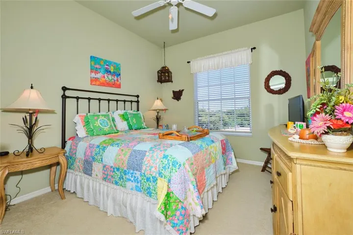 Bedroom featuring a ceiling fan and light colored carpet