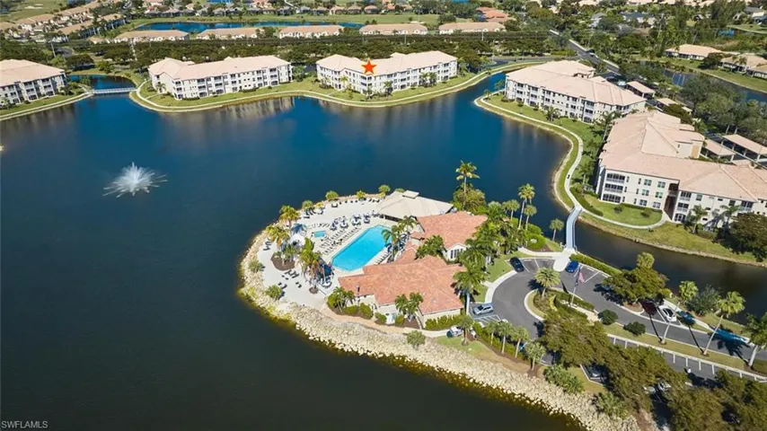 Aerial view of property and surrounding area with apartment complex and a large body of water