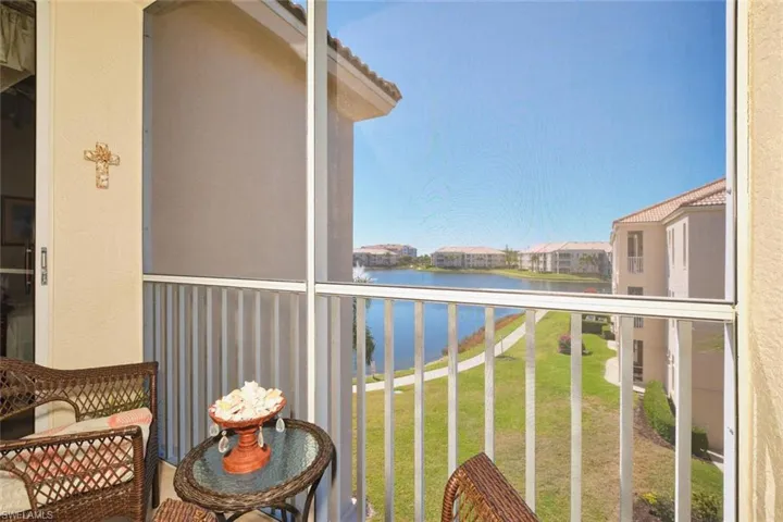 Balcony with a sunroom and a water view