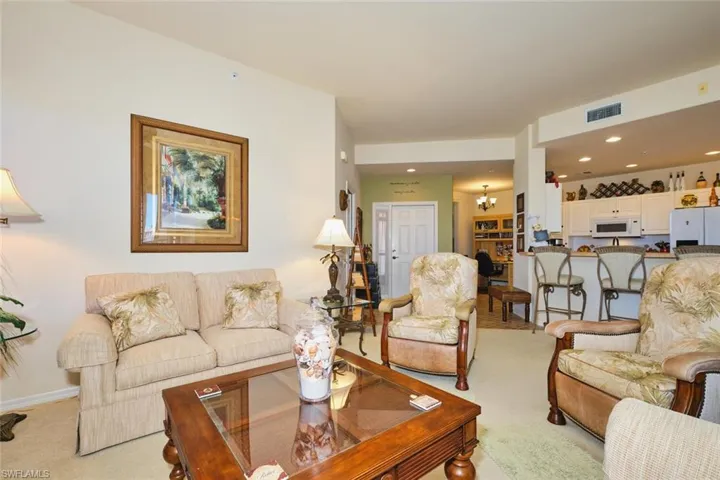 Living area featuring a chandelier and light carpet