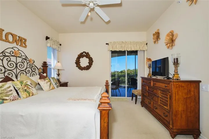 Bedroom with carpet flooring, access to outside, and a ceiling fan