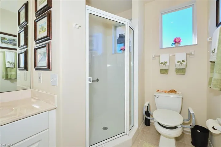 Bathroom with a shower stall, vanity, and light tile patterned floors