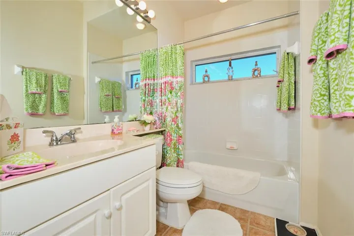 Bathroom with vanity and shower / tub combo with curtain