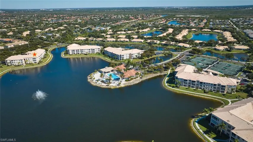 Aerial view of apartment complex and a large body of water
