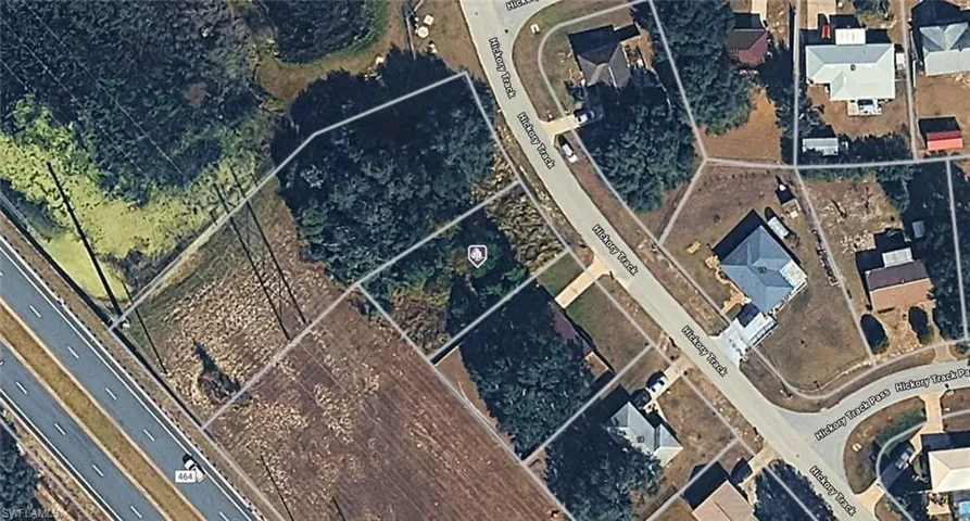 Aerial View. Depicting a residential area with multiple parcels and a roadway