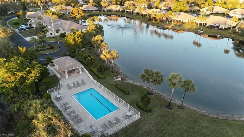 Birds eye view of property with a water view