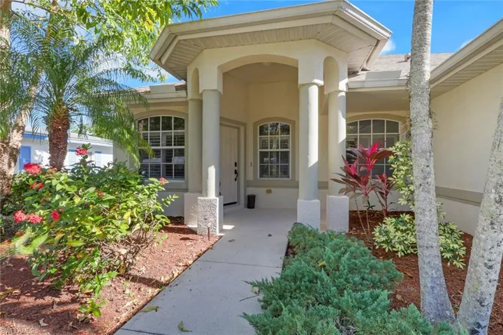 Doorway to property featuring stucco siding and a porch