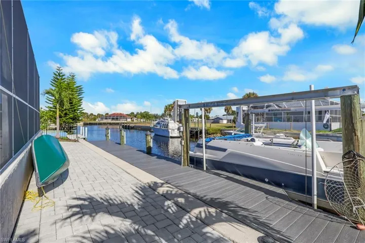 Dock area with a water view and glass enclosure
